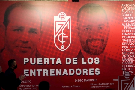 Diego Martínez, mejor entrenador de la historia del Granada tras la votación organizada por la AEPD, aplaude frente a su rostro, junto al de Joseíto, en la Puerta de los Entrenadores (JOSÉ VELASCO / GRJ)